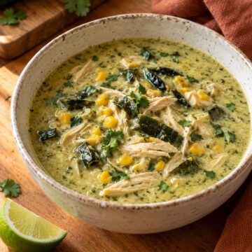 Creamy roasted poblano chicken soup with shredded chicken, corn, and cilantro.