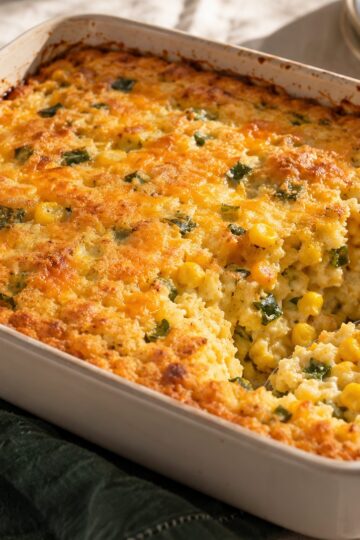 Golden corn casserole with small roasted poblano pieces and cheddar