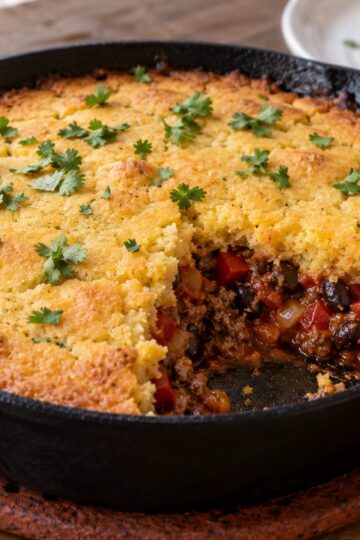 Skillet tamale pie with a golden cornbread topping and beef-and-bean filling